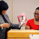 Assistant District Attorney LaQuita Long presents family photos as evidence to Botham Jean’s mother, Allison Jean, during sentencing phase for former Dallas Police Officer Amber Guyger Oct. 1, 2019.